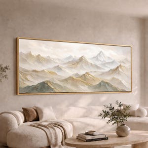 May include: A large horizontal landscape painting in a gold frame depicting a mountain range with textured peaks in shades of white, cream, and soft gold. The artwork features layered ridges and valleys with visible impasto brushstrokes.