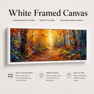 May include: A rectangular canvas print in a white frame featuring a forest path during autumn. The scene displays trees with orange, yellow, and red foliage, a sunlit trail, and dark tree trunks. Text includes White Framed Canvas, Modern White Frame, Ready to Hang, Premium Canvas Finish, White Floating Frame, and Premium Canvas.