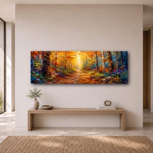 May include: A panoramic rectangular wall art print depicting a vibrant autumn forest scene with a sunlit path winding through trees featuring golden, orange, and deep red foliage, with dark tree trunks and colorful undergrowth along the forest floor.