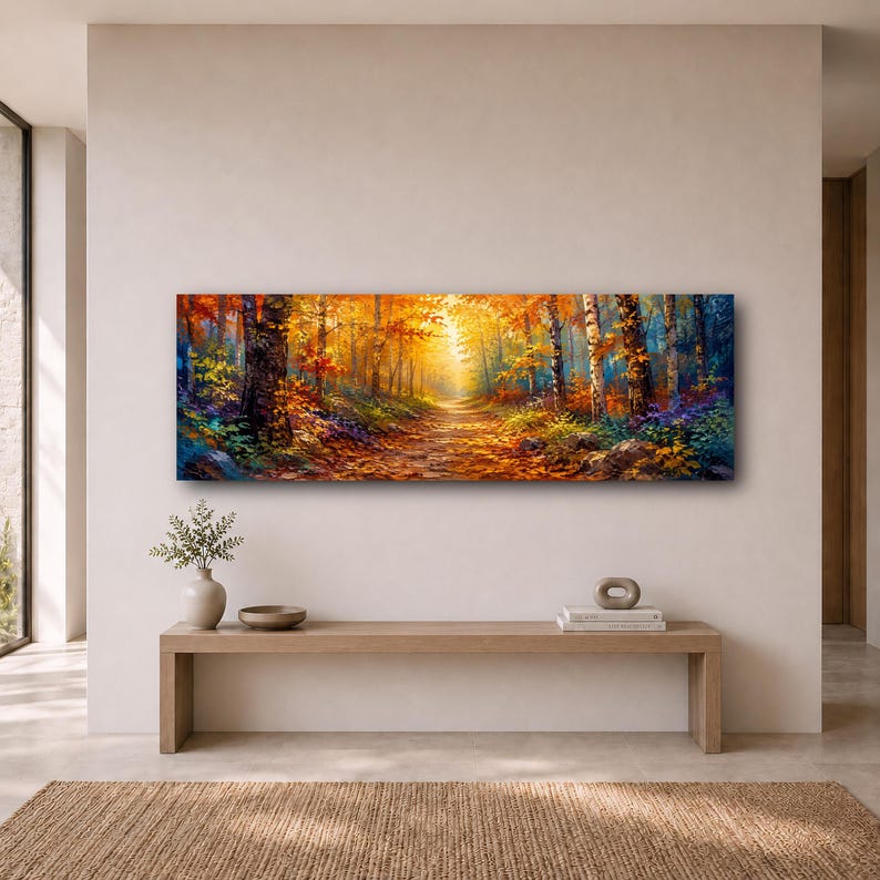 May include: A panoramic rectangular wall art print depicting a vibrant autumn forest scene with a sunlit path winding through trees featuring golden, orange, and deep red foliage, with dark tree trunks and colorful undergrowth along the forest floor.