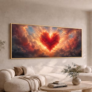 May include: A rectangular wall art piece featuring a vibrant red heart-shaped cloud formation centered amidst a dramatic sunset sky with golden light rays radiating outward, all enclosed within a thin, metallic gold-colored frame.