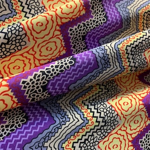 May include: Purple, yellow, red, and black geometric patterned fabric with a zig-zag design.