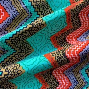 May include: A turquoise, orange, and gold fabric with a geometric pattern. The fabric has a repeating pattern of zigzags, swirls, and floral designs.