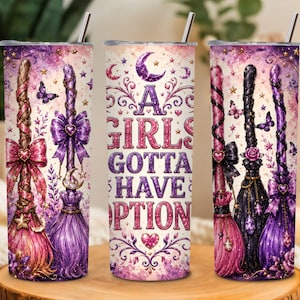 May include: A cylindrical metal tumbler with a straw, featuring a purple and pink design of three decorated broomsticks, butterflies, stars, and a crescent moon. The center displays the text A GIRLS GOTTA HAVE OPTIONS in bold lettering.