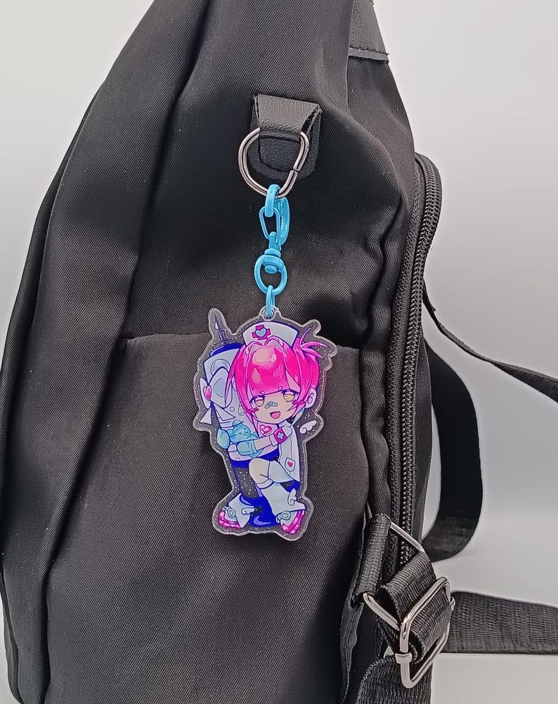 Nixi AKIMYAX character keychain displayed on a bag