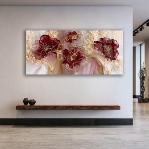 May include: A rectangular wall clock featuring a horizontal orientation with a printed design of three large, deep burgundy flowers accented by gold lines. The clock face is overlaid with a gold circular frame and Roman numerals in gold.