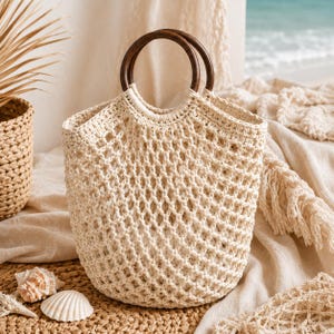 May include: A cream-colored crochet handbag featuring an open diamond-shaped mesh pattern and two circular dark brown wooden handles. The bag has a structured base and a reinforced top edge where the handles are securely attached with matching yarn.