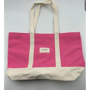 Bolso tote de lona rosa Lancôme Paris con ribete color crema. Bolso de hombro tipo shopper.