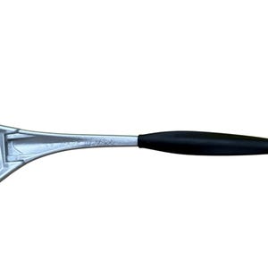 May include: A silver metal kitchen tool with a black handle. The tool is marked "MADE IN USA". The tool appears to be a spatula or similar kitchen utensil.