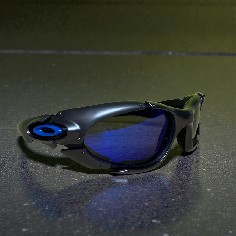 May include: Black sunglasses with blue lenses. The sunglasses have a sleek, modern design with a matte finish. The frame features a blue accent on the side. The lenses are a vibrant blue color.
