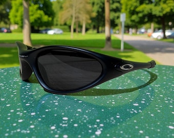 Vintage Oakley Minute 1.0 zonnebril zwarte Y2K sport wrap tinten jaren 90 cyber ovale streetwear festivalzonnebril
