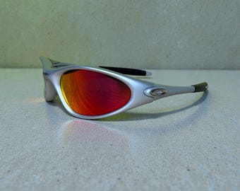 Vintage Oakley Minute Sonnenbrille Silber Orange Linse Y2K Sport Wrap around Shades 90s Techwear Streetwear