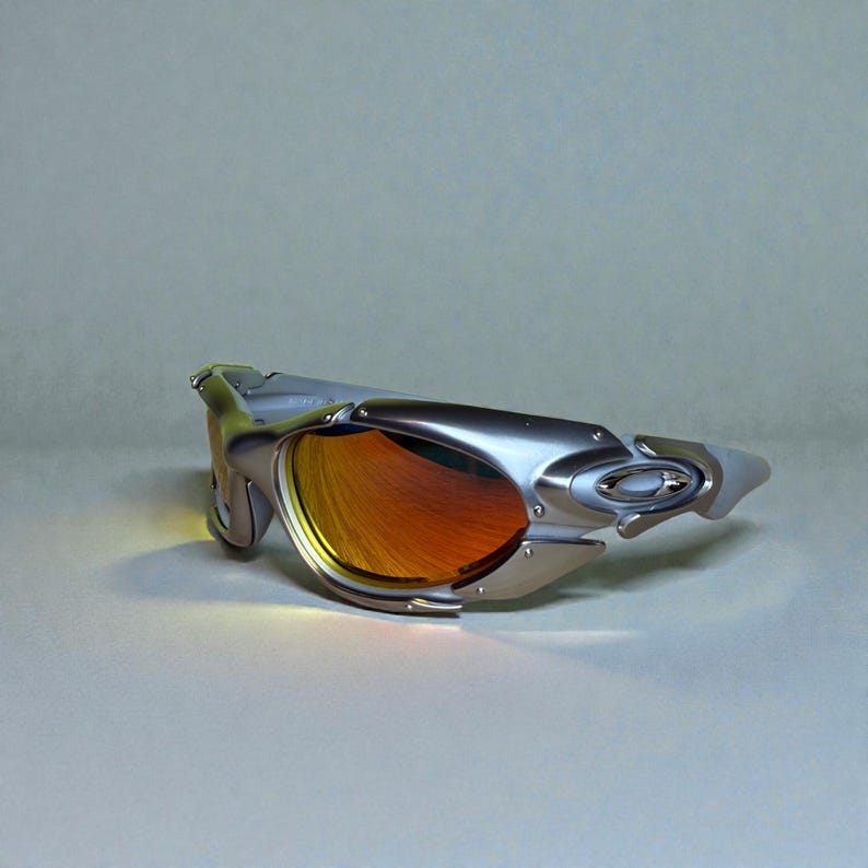 May include: Silver-framed sunglasses with orange lenses. The sunglasses have a futuristic design with a curved frame and a sleek, modern aesthetic. The lenses reflect a warm, orange hue.