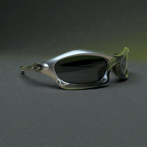 May include: Silver-framed sunglasses with dark lenses. The sunglasses have a sleek, curved design with a prominent brow bar and temples. The Oakley logo is visible on the temple. The overall aesthetic is modern and sporty.