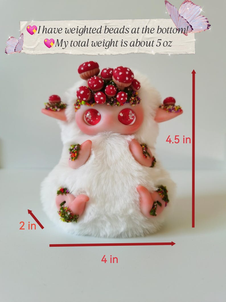 May include: A white plush creature with large red eyes, adorned with red mushroom caps and floral accents. It features weighted beads at the bottom, a total weight of 5 oz, and measures 4.5 inches in height, 4 inches in width, and 2 inches in depth.