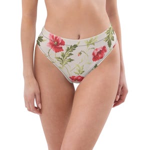 May include: High-waisted bikini bottoms featuring a light beige base color with a repeating botanical print of vibrant red poppy flowers and green leaves. The garment has a high-cut leg opening and a clean, simple waistband design.