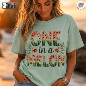 Seafoam green Comfort Colors 1717 watermelon graphic tee on female model at golden hour beach