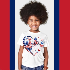 May include: A white short-sleeved t-shirt featuring a large heart-shaped graphic on the front. The design incorporates red, white, and blue colors with patterns of stars and stripes, a hibiscus flower, and several butterflies of varying sizes.