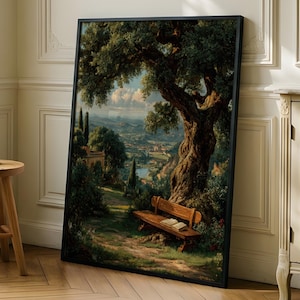 Puede incluir: Una pintura de paisaje enmarcada representa una escena de parque con un gran árbol, un banco y edificios distantes. La obra de arte tiene un marco negro y está apoyada contra una pared. Un pequeño taburete de madera con una vela está cerca.