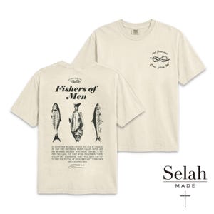 May include: Two cream-coloured t-shirts with black text and graphics. One features "Fishers of Men" above fish illustrations and a Bible verse. The other has a knot graphic and the text "And Jesus said, Come, follow Me." The brand logo is at the bottom.