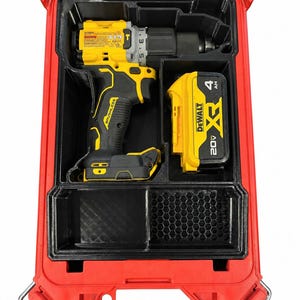 May include: A yellow and black DeWalt cordless drill and a 20V XR 4Ah battery stored inside a red hard-shell carrying case with a custom black molded insert featuring a honeycomb pattern section for organized tool storage.