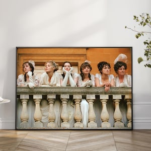 Könnte beinhalten: Ein gerahmter Kunstdruck, der fünf Personen in historischer Kleidung zeigt, die sich auf eine Steinbalustrade stützen. Die Figuren tragen weiße Kleider und Handschuhe, haben unterschiedliche Frisuren und stehen vor einem Gebäude in warmen Tönen.
