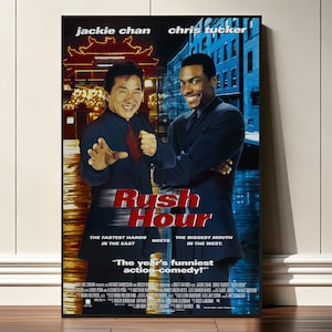 Pode incluir: Um cartaz de filme de Rush Hour com Jackie Chan e Chris Tucker em fatos escuros. O fundo mostra uma cena dividida de um edifício iluminado e uma rua azul. O título Rush Hour está em texto vermelho com o slogan The fastest hands in the east, the biggest mouth in the west.