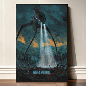 May include: A framed poster featuring a dark, atmospheric illustration of a towering, multi-legged machine emitting two bright beams of light onto a landscape. The text WAR OF THE WORLDS is printed in blue at the bottom against a dark, moody background.