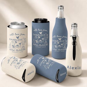 May include: A collection of beige and dusty blue beverage insulators for cans and bottles. Each features the text with love from, CHARLESTON, Ashley's Bachelorette, AUGUST 2026, and a beach graphic. Some insulators have a zipper and the name Alexis.