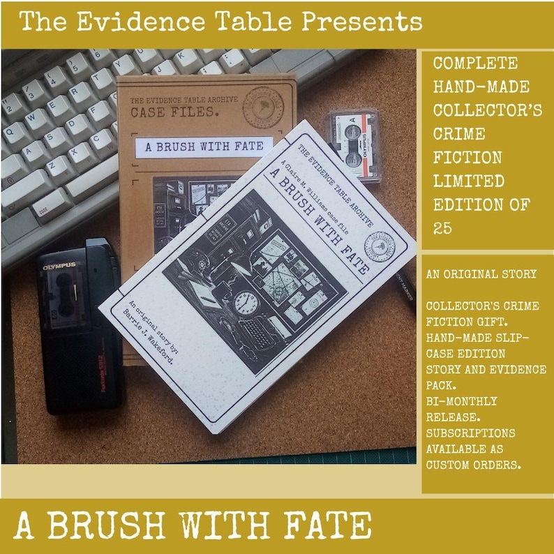 May include: A crime fiction set titled A Brush With Fate, featuring a tan slipcase, a white booklet with black illustrations, a black Olympus microcassette recorder, and a small microcassette tape, all arranged on a cork surface.