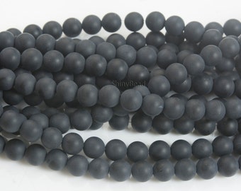 May include: A strand of matte black round beads. The beads are smooth and have a slightly textured surface.