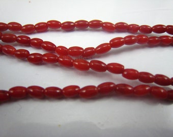 red coral rice bead 8x4mm 15 inch strand