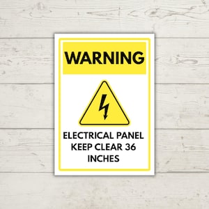 Op de afbeelding: Een rechthoekig waarschuwingsbord met een gele koptekst met het woord WARNING in zwarte letters. Daaronder staat een gele driehoek met een zwart bliksemschichtsymbool. Het witte onderste gedeelte vermeldt ELECTRICAL PANEL KEEP CLEAR 36 INCHES.