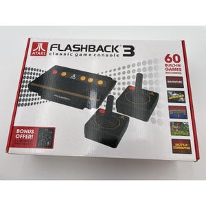 May include: Atari Flashback 3 classic game console box. The box features a black console and two joysticks. The box also includes the text "60 Built-in Games Including: Adventure, Asteroids, Missile Command". A bonus offer is also included.