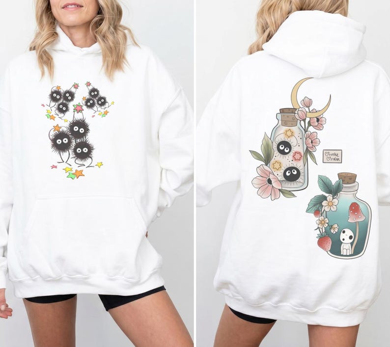 May include: White hoodie with a front graphic of black, fluffy creatures with googly eyes and a back graphic of potion bottles with floral and moon designs. The hoodie has a front pocket and a hood.
