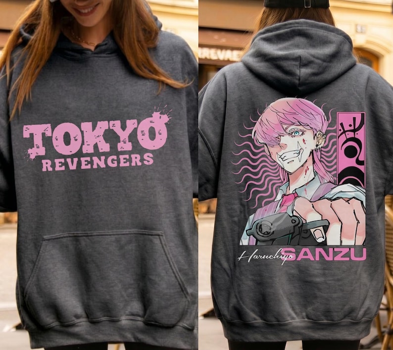 May include: Dark gray hoodie with the text "TOKYO REVENGERS" in pink on the front. The back features a pink-haired anime character with a gun, the name "Haruchiyo SANZU", and pink accents.