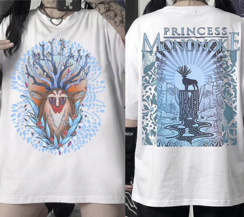 May include: White t-shirt featuring a colorful illustration of a deer-like creature with a tree-like head and a blue and orange background. The back of the shirt has the text "PRINCESS MONONOKE" above a graphic of a deer and a waterfall.