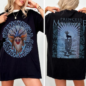 May include: Black t-shirt featuring a front graphic of a deer-like creature with a tree-like head, surrounded by blue foliage. The back of the shirt displays the text "PRINCESS MONONOKE" above a nature scene with a deer silhouette.
