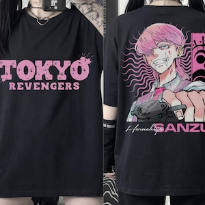 May include: Black t-shirt featuring the text "TOKYO REVENGERS" in pink on the front. The back of the shirt displays an anime-style illustration of a character with pink hair, holding a gun, with the name "Haruchiyo SANZU".