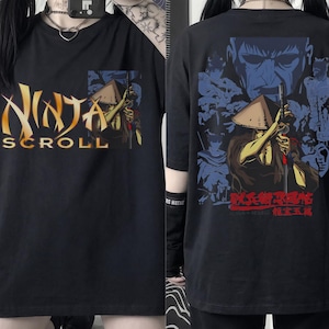 May include: A black short-sleeved t-shirt featuring a graphic print of the Ninja Scroll logo and a character in a conical hat on the front. The back displays a large, detailed illustration of the same character with red Japanese text.