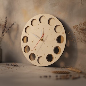 May include: A circular light-colored wooden wall clock featuring twelve circular cutouts arranged around the perimeter. The clock face is decorated with small engraved star patterns and includes two white hour and minute hands along with a thin red second hand.