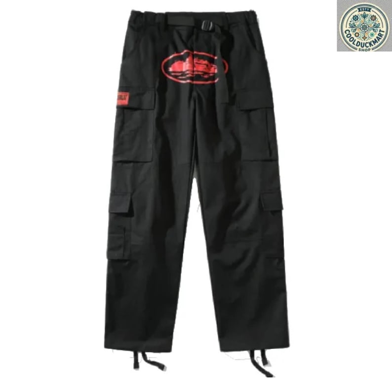 May include: Black cargo pants with multiple pockets and a belt. A red graphic is printed on the front. The pants have a relaxed fit and are made of a durable fabric. The pants have a drawstring at the bottom of each leg.