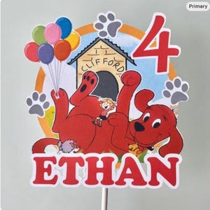 May include: A red Clifford the Big Red Dog cake topper with the name "ETHAN" and the number "4". The topper features Clifford, a girl, a dog house, balloons, and paw prints. The background is a light blue and yellow circle.