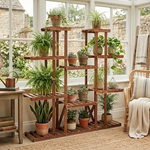 May include: A multi-tiered, wooden plant stand filled with various potted plants. The stand is made of dark brown wood and has multiple shelves of varying sizes. The plants include ferns, succulents, and other greenery, creating a natural, indoor garden display.