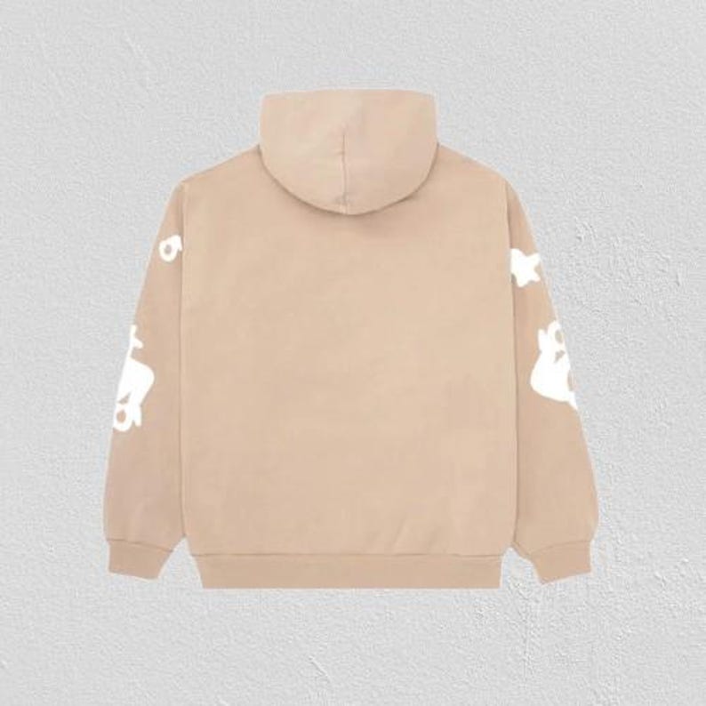 May include: A tan hoodie with a hood and long sleeves. White graphic designs are printed on the sleeves. The hoodie is made of a soft material and is suitable for casual wear.