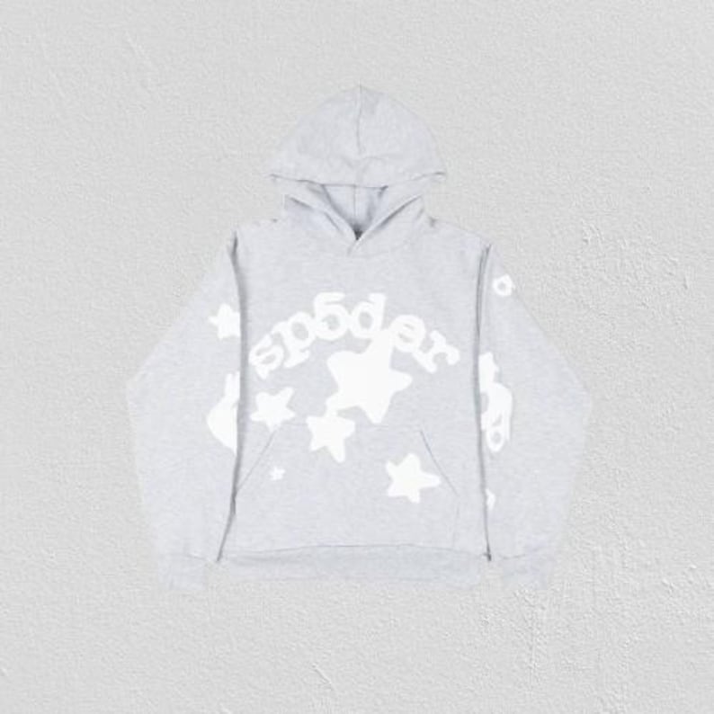May include: A light gray hoodie with a hood and a kangaroo pocket. The front features the word "sp5der" in white, along with white star graphics. The sleeves also have white graphics. The hoodie is made of a soft, comfortable material.