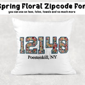 May include: White cushion with a floral design in blue, red and yellow. The numbers 12148 are printed on the cushion in a blue outline. The text "Poestenkill, NY" is printed below the numbers.