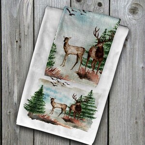 May include: Two watercolor illustrations of deer in a forest setting. The top illustration features a doe and a buck standing in a clearing with trees and flying birds in the background. The bottom illustration features a doe and a buck standing in a clearing with trees in the background.