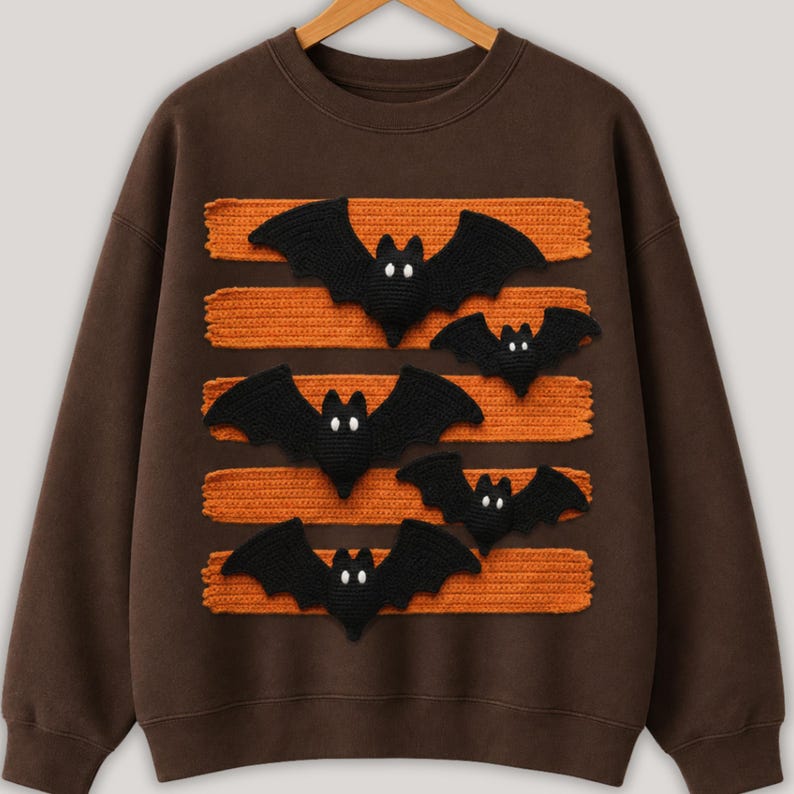 Halloween bat design in PNG format with black bats and orange patterned lines displayed on comfy t-shirt samples in charcoal, brown, olive green, rusty orange and cream for sublimation printing for the horror season and DTF t-shirts.