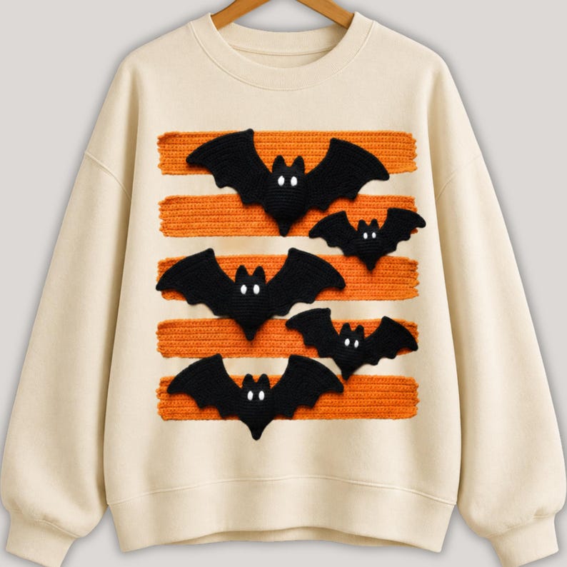 Halloween bat design in PNG format with black bats and orange patterned lines displayed on comfy t-shirt samples in charcoal, brown, olive green, rusty orange and cream for sublimation printing for the horror season and DTF t-shirts.